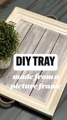 a potted plant sitting on top of a wooden table next to a sign that says diy tray made from a picture frame