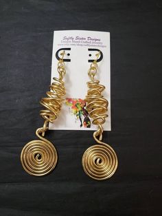 "Beautiful gold colored aluminum wire wrapped earrings are a totally unique abstract design and are 5\" inches long with gold plated leverback earwires. Please come back and visit to check for new unique designs. For more styles visit my Etsy shop: www.etsy.com/shop/SoftlySisterDesigns" Wire Wrapped Metal Earrings For Party, Spiral Wire Wrapped Earrings For Party, Wire Wrapped Metal Drop Earrings, Wire Wrapped Spiral Earrings For Parties, Party Spiral Wire Wrapped Earrings, Party Wire Wrapped Metal Earrings, Adjustable Wire Drop Earrings, Adjustable Spiral Earrings For Party, Artsy Wire Wrapped Dangle Jewelry