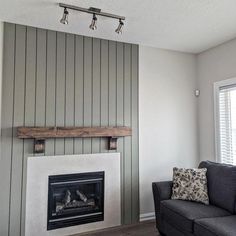 a living room with a couch, chair and fireplace