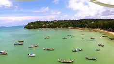 several boats floating in the water near an island