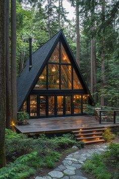 a - frame cabin in the woods with stairs leading up to it's entrance