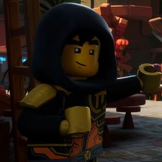 the lego movie character is holding his arm out