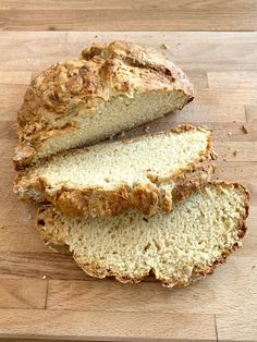 sliced loaf of bread sitting on top of a wooden cutting board