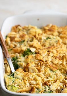 a casserole dish with broccoli, cheese and bread crumbs