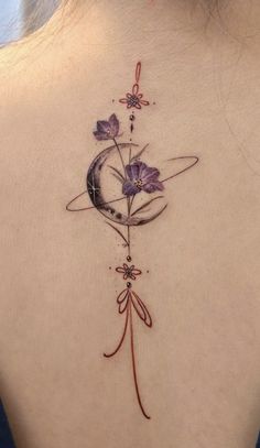 the back of a woman's neck with flowers on it and an arrow in the middle