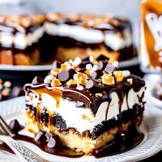 a piece of cake sitting on top of a white plate with chocolate and marshmallows