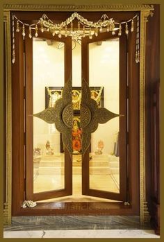 an ornately decorated wooden door with glass panels