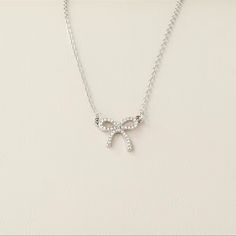 This Posting Is For One Silver Colored Bow Necklace. Very Timeless Piece Of Jewelry. Super Cute For An Adult Or Young Woman. Wonderful Costume Piece Of Jewelry For Your Collection. Condition: Brand New Color: Silver Fast And Careful Shipping! Prom Jewlrey Looks Silver, Dainty Silver Rhinestone Necklace For Party, Delicate Bridal Necklace With Clavicle Chain For Party, Delicate Bridal Necklace With Adjustable Chain For Party, Dainty Rhinestone Necklace With Adjustable Chain For Party, Delicate Cubic Zirconia Necklace For Party, Dainty Rhinestone Choker For Party, Dainty Rhinestone Necklace With Clavicle Chain For Parties, Dainty Rhinestone Clavicle Necklace For Parties