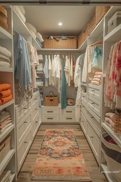 a walk in closet filled with lots of clothes and rugs on top of wooden flooring