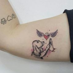 a woman's arm with a tattoo on it and a dog holding a heart