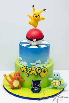 a pokemon themed birthday cake with pikachu on top