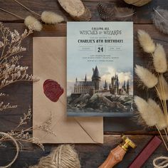 a harry potter themed birthday card with wax stamp and some dried flowers on a wooden table