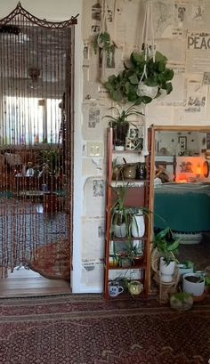 a living room filled with lots of potted plants next to a doorway covered in papers