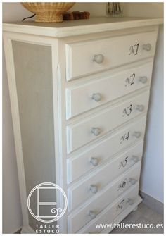 a white dresser with drawers and numbers on it