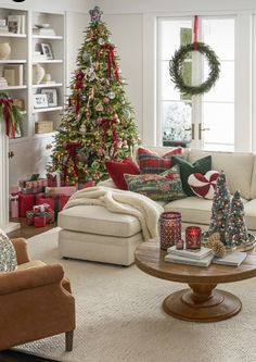 a living room filled with furniture and christmas decorations