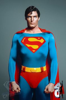 a man dressed in superman costume standing with his hands on his hips