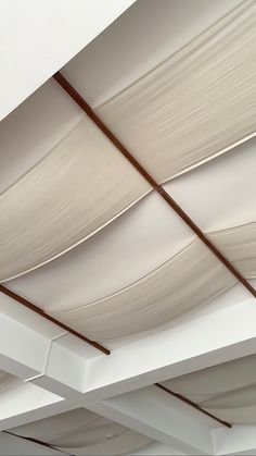 the ceiling is covered with white drapes