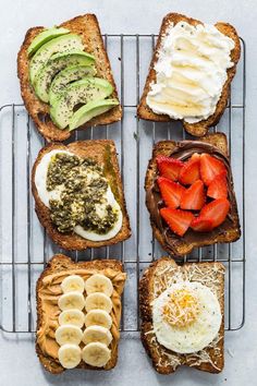 four slices of toast with different toppings on them, sitting on a cooling rack