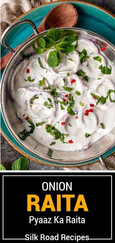 an image of onion raita with yogurt in a blue bowl on a table