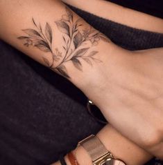 a woman's foot with a flower tattoo on it