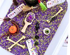 there are many different items on the purple mat that is covered with beads and other things