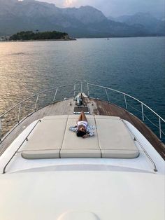 a person laying on the back of a boat