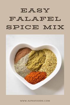 an easy falafel spice mix in a heart shaped bowl with text overlay