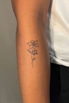 a woman's arm with a tattoo on it and a flower in the middle