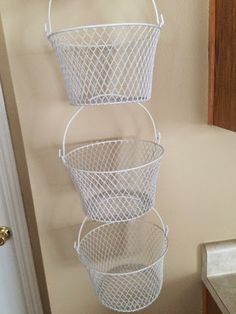 three metal baskets hanging on the wall