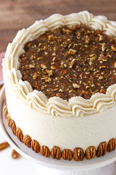 a cake with pecans around it on a plate