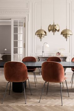 a dining room table with six chairs and a chandelier hanging from the ceiling