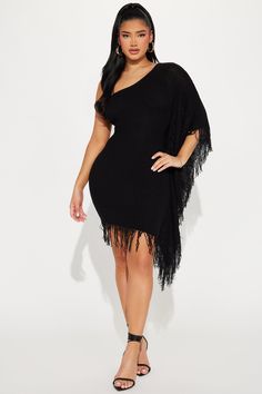 a woman wearing a black fringed dress