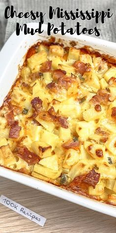 a casserole dish with cheese and ham in it on a wooden table top