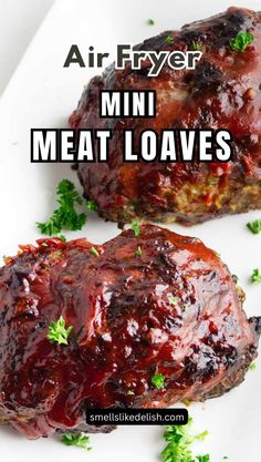 two meat loaves sitting on top of a white plate with the words air fryer mini meat loaves