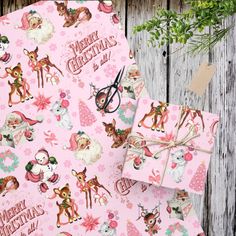 pink christmas wrapping paper with deer and reindeers on it