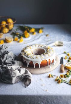 a bundt cake sitting on top of a table next to lemons