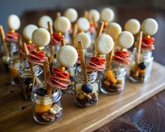 small glass jars filled with food on top of a wooden table