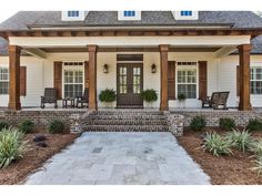 a white house with wood trim and columns