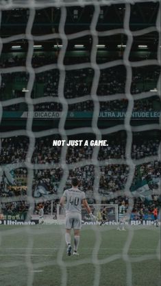 a soccer goalie looking at the ball in front of him and saying not just a game