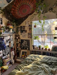 a bedroom with lots of plants and pictures on the wall