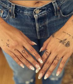 a woman's hands with tattoos on them