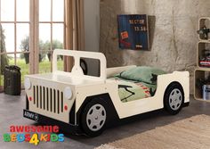 a child's bed in the shape of a car