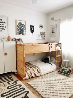 a bedroom with a bunk bed and rugs on the floor