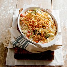 a casserole dish with cheese and vegetables in it on top of a napkin