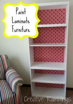 a white book shelf with red and white wallpaper on it, next to a striped chair