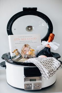 a white crock pot filled with wine and other items