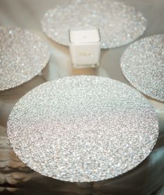 four silver glittered coasters sitting on top of each other