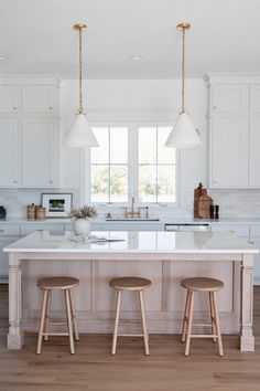 two stools sit at the center of this kitchen island