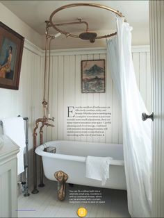 an old fashioned bathtub in a bathroom with white walls and wood paneled floors