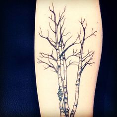 a tattoo with two trees on it and one is black and white, the other is blue